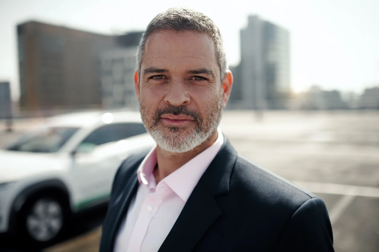 Man next to MyWheels car for business meeting